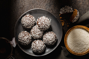 Coconut chocolate balls on plate. Top view.