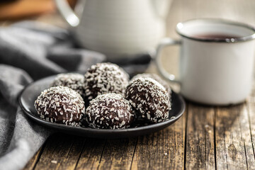 Coconut chocolate balls on plate.