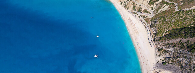 Aerial drone ultra wide panoramic photo of tropical Caribbean island bay with white sand beach and beautiful turquoise and sapphire clear sea forming a blue lagoon