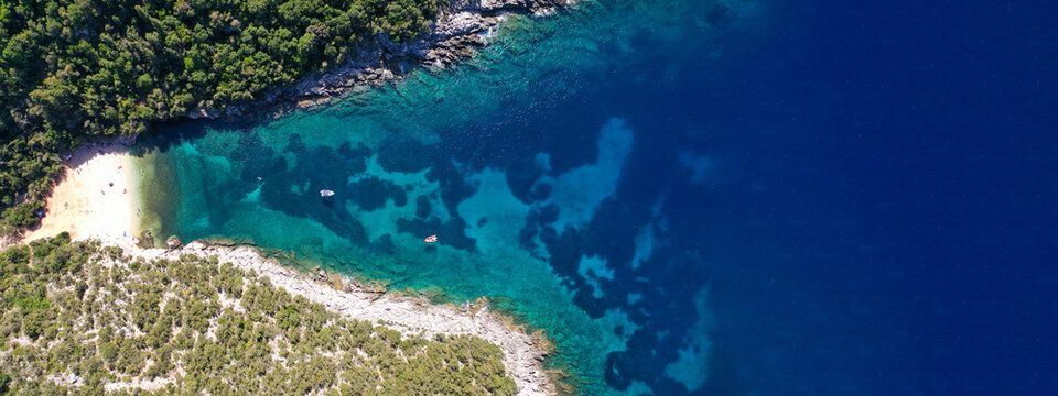 Aerial drone ultra wide panoramic photo of tropical Caribbean island bay with white sand beach and beautiful turquoise and sapphire clear sea forming a blue lagoon © aerial-drone