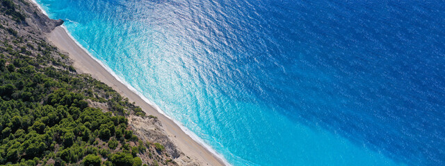 Aerial drone ultra wide panoramic photo of tropical Caribbean island bay with white sand beach and beautiful turquoise and sapphire clear sea forming a blue lagoon