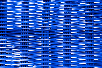 abstract design close up of neon blue cottage wicker chair with vertical and horizontal lines with light shining through the wicker design horizontal format room for type abstract cottage backdrop 