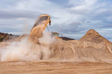 Tipper truck for exclusive use in mines, works and quarries unloading sand in a stockpile.