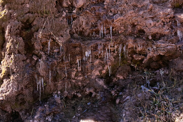 ice formation on rocks and earth, very cold and melting snow