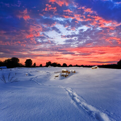 snowbound plain at the dramatic sunset, winter outdoor evening scene