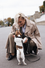 happy dog owner with puppy training on the street, walking with dog, puppy owner, woman with dog on...