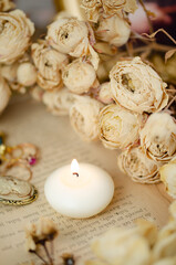 decoration, candle, roses and rings on an old book