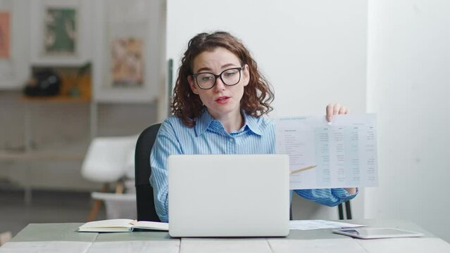 Young professional business woman manager leader using laptop, talking, managing remote team leading presentation having virtual work conference hybrid online meeting training video call in office.