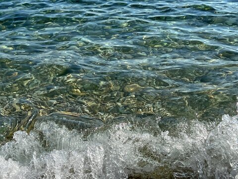 Sea waves flowing on the pebble beach.