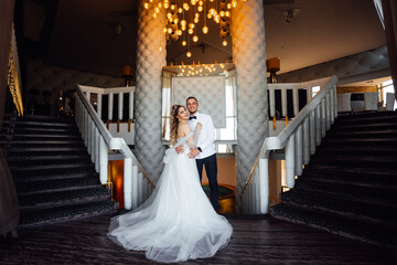 beautiful couple in love. stylish groom with the bride in a wedding dress