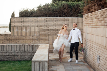 beautiful couple in love. stylish groom with the bride in a wedding dress