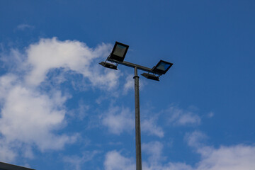 stadium lights against blue sky