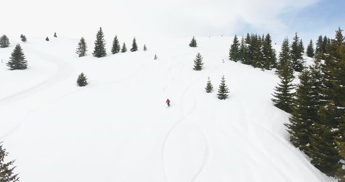 Happy skier having fun and high adrenaline while skiing backcountry on a sunny winter day in snowy mountains. Extreme freeride skiing in the fresh powder snow off-piste