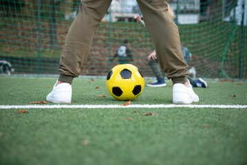 a little boy plays soccer with his father on the soccer field © Natalje Dietrich