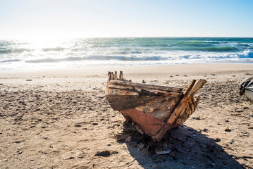 Fototapeta na wymiar Old boat stranded on the beach