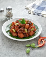 Sambal goreng kentang hati ampela. The chili sauce for fried potatoes ati ampela is a red balado seasoning that is added with candlenut and shrimp paste. Eid al-Fitr menu, served on plate