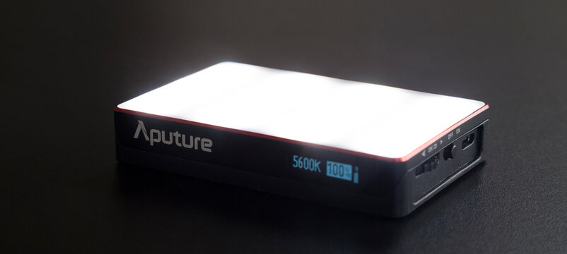 Led aputure MC lit on top of a black table. Brightness of light. LED concept. Lighting concept.