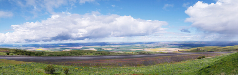 Obraz premium Rest Area Panoramic View - The rain clouds are at eye level while observing the scenic view on top of Emigrant Hill in Eastern Oregon. Emigrant Hill, commonly called “Cabbage Hill” 