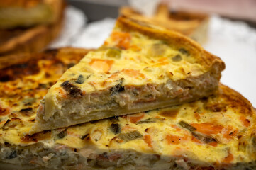 Traditional French quiche vegetable pie with green courgette and carrot