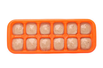 Banana puree in ice cube tray isolated on white, top view