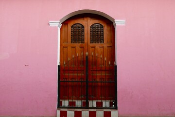 Wooden Door in Pink Building
