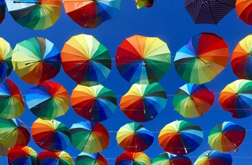 Colorful umbrellas on display hanging from above. 