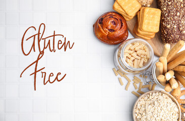 Different gluten free products on white tiled table, flat lay