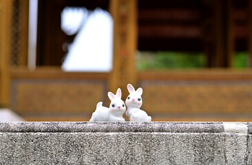 Closeup of Rabbits Stucco Doll with natural background for design and decoration in the garden at thailand.