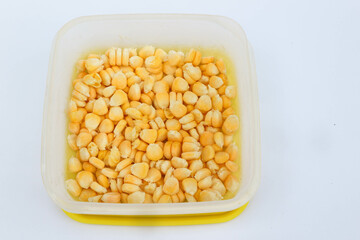 Pile of frozen corn isolated on white. Vegetable preservation