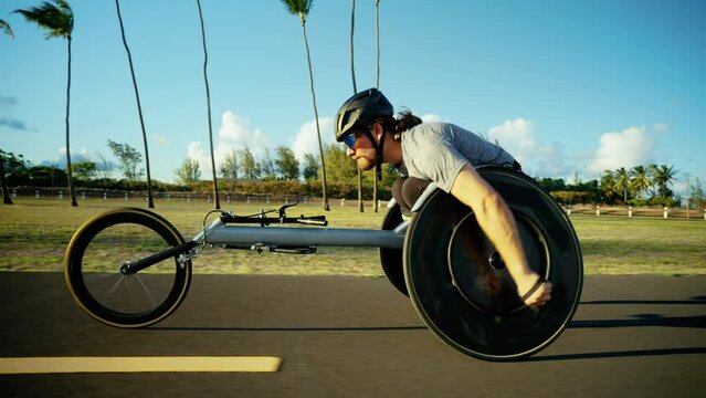 Disabled wheelchair paralympic athlete in wheelchair racing chair outside working out healthy lifestyle
