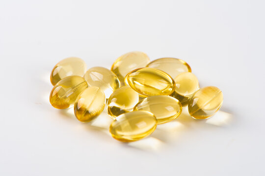 Vitamin E. Supplementary food. Omega 3. Gold fish oil gel Capsules isolated on white background.