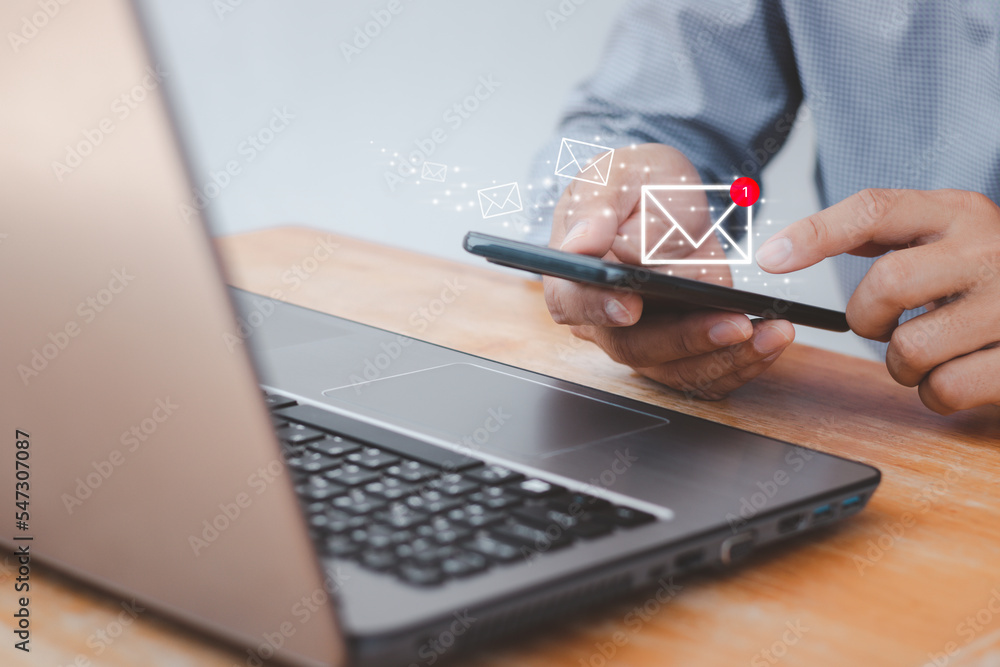 Poster close up of a man's hand holding smartphone and checking email online on the web with virtual interf