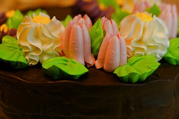 birthday cake in chocolate icing with cream flowers