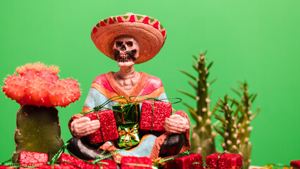 Latino skeleton holding Christmas presents with cactus.
