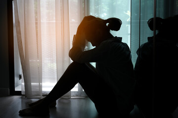 woman sitting in the corner of the room have emotional and mental problems He has depression and...