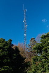 Radio tower with microwave dishes and vertical antennas.