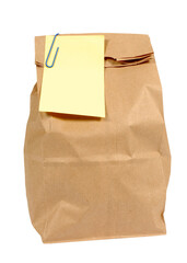 Brown paper school packed lunch or grocery bag with sticky note isolated transparent background photo PNG file