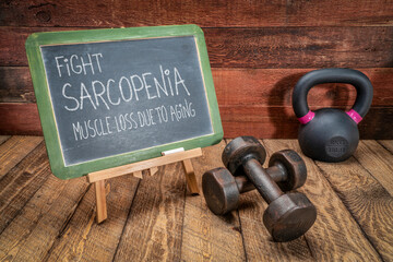 fight sarcopenia, muscle loss due to aging - inspirational message on a blackboard with dumbbells and a kettlebell, senior health and fitness concept