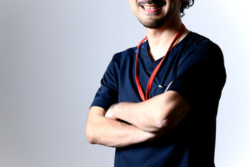 Image of Asian male doctor in scrubs with arms crossed.