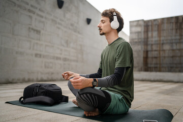 one man doing guided meditation online yoga self care concept outdoor