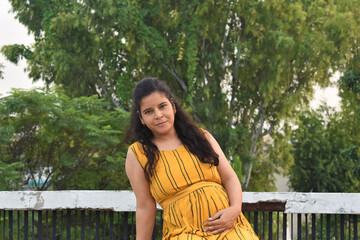 Six months Pregnant Indian Woman with nature background