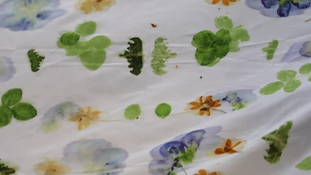 opening sheets of Indonesian batik cloth. printed using the ecoprint system.