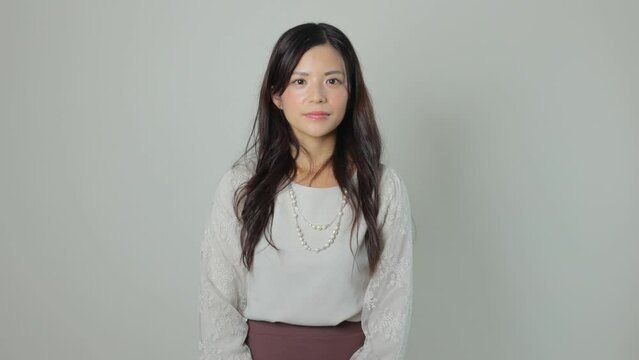 Beautiful asian woman opens her eyes and stares the camera. Emotionless, Still, Protest. 25P