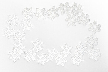 Frame of small white felt snowflakes, celebrating winter holidays
