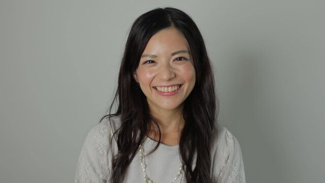 Asian beautiful woman smiles at the camera. Happy, Joy, Delighted. Dolly in. 25P