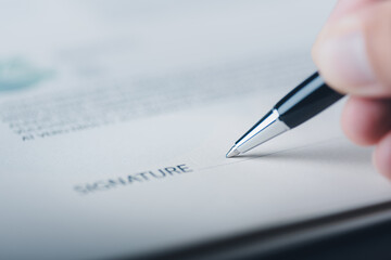 Young businessman hand using pen to sign signature, contract agreement concept, employment, acceptance and approval in business. Legal Document Management