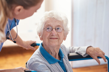 Disability, nursing and senior woman with a doctor for care, consultation and medical help at a hospital. Healthcare, communication and elderly patient in a wheelchair with a nurse in a home
