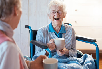 Senior woman, friend and coffee or tea while in a wheelchair for a disability or rehabilitation and happy or laughing about funny conversation or joke. Old people together for fun in nursing home - obrazy, fototapety, plakaty