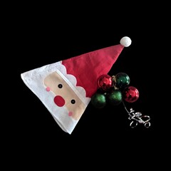  Christmas theme image with a Santa Clause hat isolated on a black background.