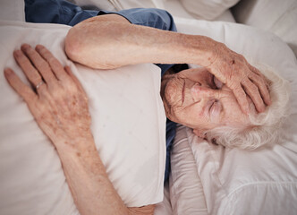 Headache, pain and senior woman in bed for trauma recovery, rehabilitation or rest in elderly care...